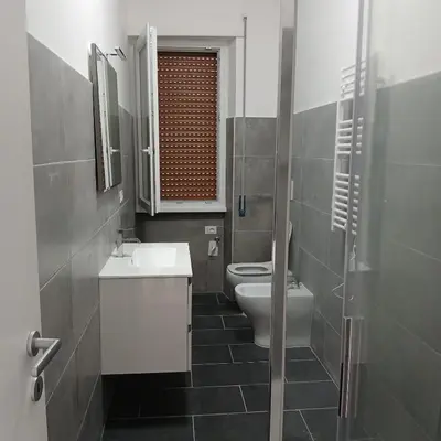 a bathroom with a toilet and a sink and a mirror at Grand Nomentana Roma in Rome