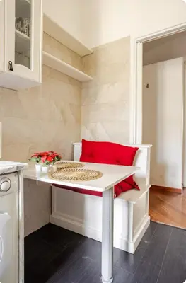 a kitchen with a white table and red pillows at Domus Prestige Vaticano 