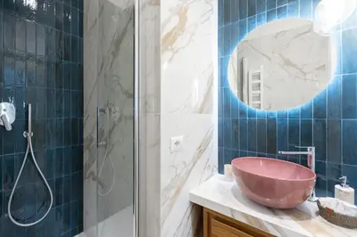 a bathroom with a pink sink and a shower at La dolce vita Cavour in Rome