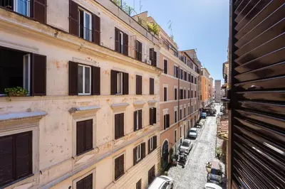 a view of an alley between two buildings at La dolce vita Cavour in Rome