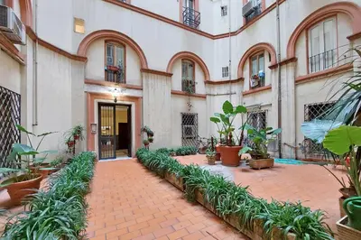 a courtyard with plants in front of a building at Vatican Museums Art Apartment in Rome