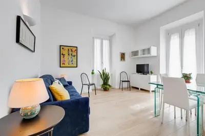 a living room with a blue couch and a table at Casa di Zio Colosseo in Rome