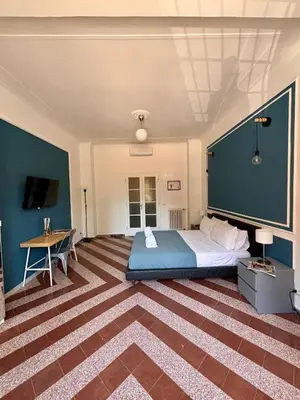 a bedroom with a large bed and a table at The Place Strozzi in Rome