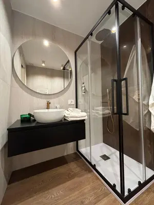 a bathroom with a sink and a shower at Atrium Regal Room in Rome
