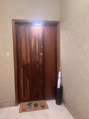 a wooden door in a room with a trash can at Grazioso appartamento Tiburtina - 3 bedrooms in Rome