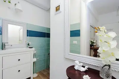 a bathroom with a sink and a mirror at Trastevere 50DUE Apartment in Rome