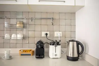a kitchen counter with a coffee maker on a counter top at Vatican Stay in Rome