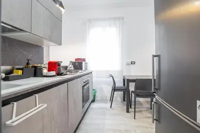 a kitchen with a counter and a table with chairs at kathy Home Rome Suite in Rome