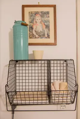 a wire basket with a picture of a girl on a wall at Apartment in the center of Rome in Rome