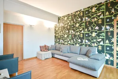 a living room with a couch and a wall at Splendido attico a Roma in Rome