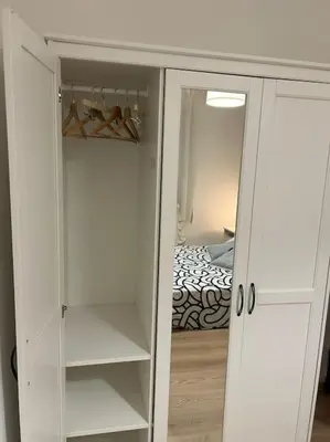 a white cabinet with a mirror in a bedroom at Caroline Home in Rome