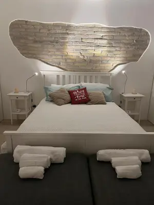 a bedroom with a large bed with two night stands at Malila's-Cipitelli Trevi in Rome