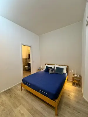 a bedroom with a large blue bed in a room at Malila's-Cipitelli San Pietro in Rome