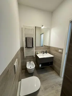 a bathroom with a sink and a toilet and a mirror at Malila's-Cipitelli San Pietro in Rome