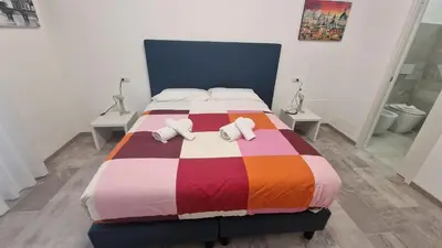 a bedroom with a bed with two pillows on it at Relux Pretoria Rooms in Rome