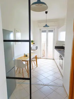a kitchen with a table and a dining room at Rooftop Apartment Quadraro in Rome