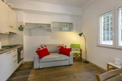 a living room with a couch with two red pillows at Arbia Stay in Rome