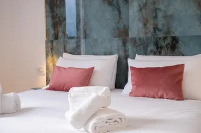 a bedroom with a bed with red and white pillows at Bhr Brancaccio 83 in Rome