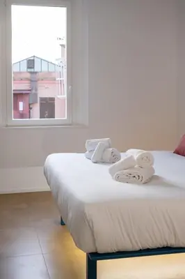 two twin beds in a room with a window at Bhr Brancaccio 83 in Rome