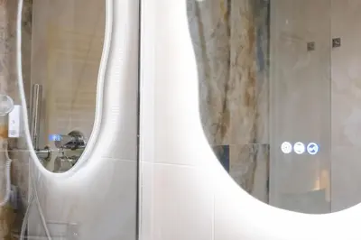 a bathroom with two mirrors and a shower at Bhr Brancaccio 83 in Rome