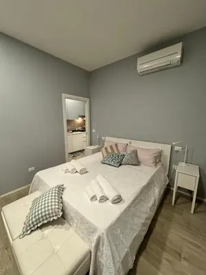 a bedroom with a bed with two slippers on it at Malila's - Cipitelli Spagna in Rome