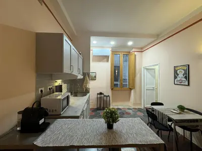 a kitchen with a table and a counter top at Le Due Torri in Rione Monti in Rome