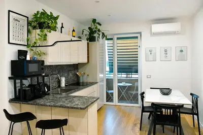 a kitchen and dining room with a table and chairs at Dima Home Cute Flat in Rome in Rome