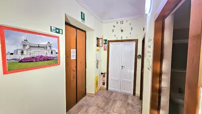 a hallway with a painting of a white building at Casa Simpatia Roma Vaticano in Rome