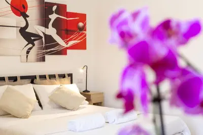 a bedroom with a bed and a painting on the wall at La casa di Elba in Rome