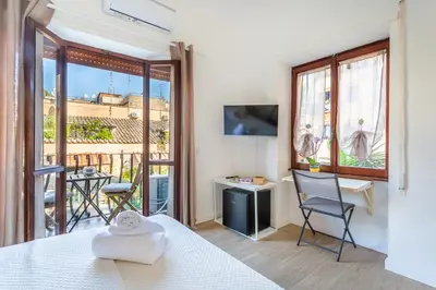 a room with a bed and a view of a balcony at La casa di Elba in Rome