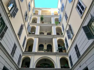 a large building with a balcony with plants on it at Non prenotate in Rome