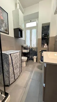 a bathroom with a bed and a sink and a toilet at Casa Gaia - Cozy Urban Oasis in Rome
