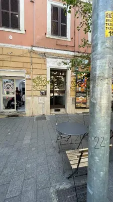 a table and chairs in front of a building at Casa Gaia - Cozy Urban Oasis in Rome