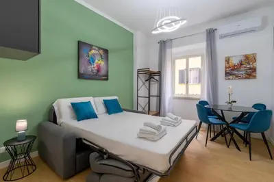 a small room with a bed and a table at Metro A 3 fermate da San Pietro - 2 Camere Luminoso - Domus Valeria in Rome