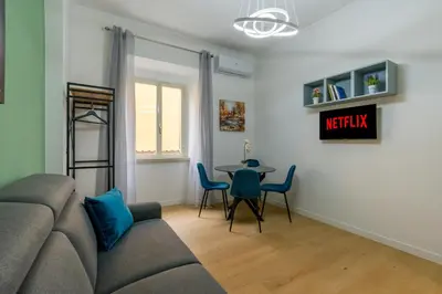 a living room with a couch and a table at Metro A 3 fermate da San Pietro - 2 Camere Luminoso - Domus Valeria in Rome
