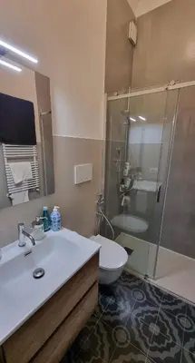 a bathroom with a sink and a shower and a toilet at Maggie's House in Rome