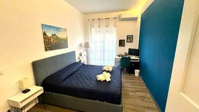 a teddy bear sitting on a bed in a bedroom at Trastevere Welcome Home Deluxe 2 in Rome