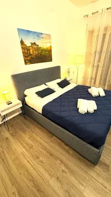 a teddy bear sitting on a bed in a bedroom at Trastevere Welcome Home Deluxe 2 in Rome