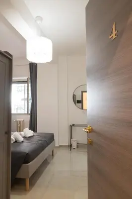 a bedroom with a bed and a mirror and a door at Gmm in Rome
