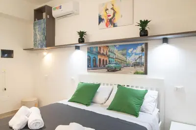 a bedroom with a bed with green and white pillows at Gmm in Rome