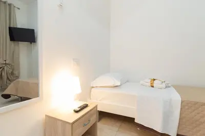 a small bedroom with a bed and a mirror at Casa Sole in Rome