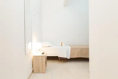 a bedroom with a bed and a mirror at Casa Sole in Rome