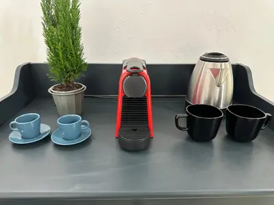 a juicer sitting on top of a table with cups at Via Veneto - Dolce Vita Alcova in Rome