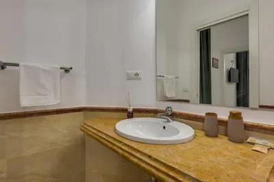 a bathroom with a sink and a mirror at Via Veneto - Dolce Vita Alcova in Rome