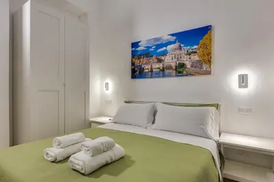 a bedroom with a large bed with towels on it at Via Veneto - Dolce Vita Alcova in Rome