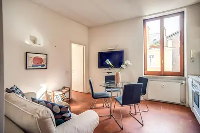 a living room with a table and chairs at Coliseum charming house in Rome