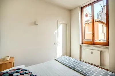 a bedroom with a bed and a window at Coliseum charming house in Rome