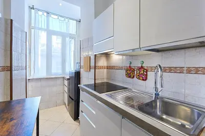 a kitchen with a stainless steel sink and a window at Close to the Spanish Steps, WIFI, Air Cond, 2 bedrooms in Rome