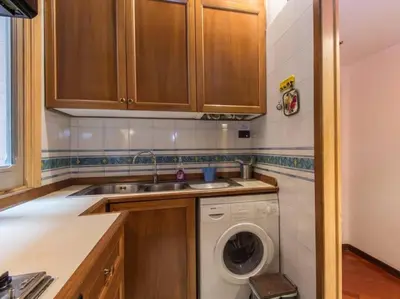 a kitchen with a sink and a washing machine at Piazza Navona Charming Apartment in Rome