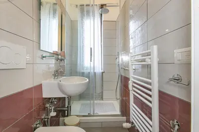 a bathroom with a toilet and a sink and a shower at Rosso Levanto House in Rome